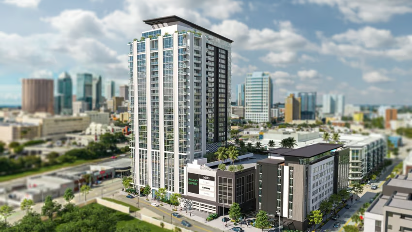 High-rise apartment tower and mixed-use buildings against the Tampa skyline